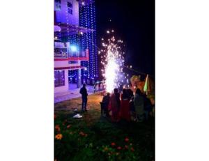 a group of people watching a fireworks show at night at Hotel Auli Inn, Joshimath in Joshīmath