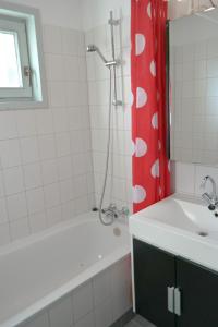 a bathroom with a tub and a sink and a shower at Natascha 6pers House Near Lauwersmeer National Park in Anjum