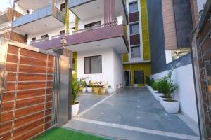 a courtyard of a house with a wooden fence at Lime Tree Premier near Medanta Medicity in Gurgaon