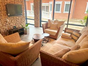 a living room with two couches and a television at Bikeaway Guesthouse in Kereki