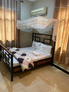 a bedroom with a bunk bed with a canopy at Peacefully Resort in Dodoma