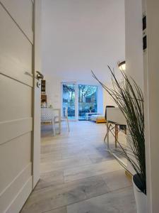 a hallway with a door open to a living room at Haas Apartments Slepa, city centre, parking, courtyard in Brno