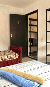 a bedroom with two beds and a sliding glass door at RustiCidade in São Paulo