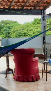a red chair with a hammock on top of it at RustiCidade in Sao Paulo