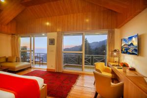 a bedroom with a bed and a large window at Yog Wellness Resort & Spa By Amritara in Mussoorie