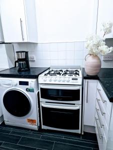 a kitchen with a stove and a microwave at 1 bedroom flat London in London