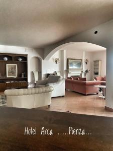 a large living room with couches and a couch at Arca Hotel in Pienza