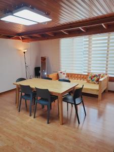 Habitación con mesa, sillas y sofá en LINDSAY, en Seúl