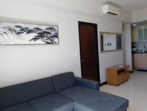 a living room with a couch and a painting on the wall at Mactan Newtown Beach Condo in Mactan