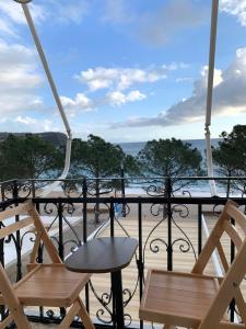 a balcony with two chairs and a view of the ocean at Mateo in Himare