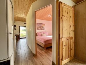 a bedroom with a bed and a door to a room at Landhaus Waidblick in Wischeid