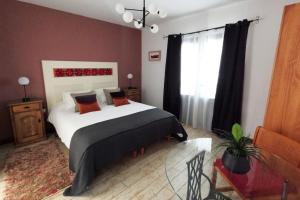 a bedroom with a large bed and a window at MoonLava: Apto, Piscina, WiFi in Yaiza