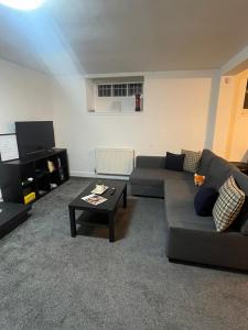 a living room with a couch and a coffee table at Boyds Entry flat Old town in Edinburgh