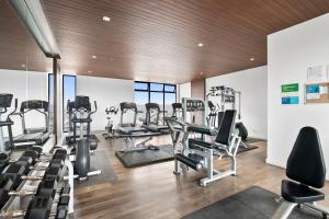 a gym with treadmills and elliptical machines at Downtown Apartment with Balcony City View, Gym & Lounge in Tijuana