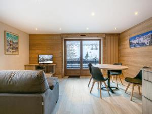 a living room with a couch and a table at Appartement La Clusaz, 3 pièces, 6 personnes - FR-1-304-271 in La Clusaz