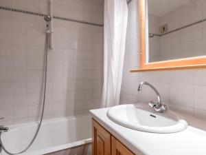een witte badkamer met een wastafel en een douche bij Appartement La Clusaz, 2 pièces, 4 personnes - FR-1-304-81 in La Clusaz