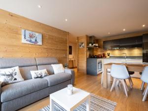 a living room with a couch and a kitchen at Appartement La Clusaz, 2 pièces, 4 personnes - FR-1-304-272 in La Clusaz