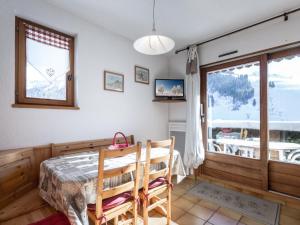 a dining room with a table and a window at Appartement La Clusaz, 2 pièces, 5 personnes - FR-1-304-53 in La Clusaz