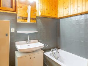 a bathroom with a sink and a bath tub at Chalet La Clusaz, 5 pièces, 8 personnes - FR-1-304-243 in La Clusaz