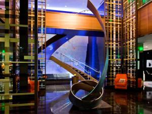 a spiral staircase in a lobby with a building at Hotel Sofitel Los Angeles at Beverly Hills in Los Angeles