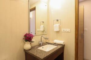 a bathroom with a sink and a mirror at Veera Strand Park Serviced Apartments near Calangute in Calangute
