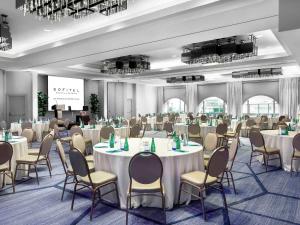 a conference room with tables and chairs and a stage at Hotel Sofitel Los Angeles at Beverly Hills in Los Angeles