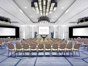 a conference room with a row of chairs and a screen at Hotel Sofitel Los Angeles at Beverly Hills in Los Angeles