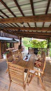 a wooden table and chairs on a patio at DOMEK NA GÓRACH z GORĄCĄ BALIĄ i SAUNĄ in Nowy Sącz +31 photos
