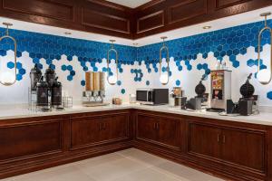 a kitchen with blue and white tiles on the wall at La Quinta by Wyndham Madison American Center in Madison