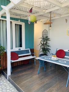 a porch with two benches and a table at Vandana's Bed and breakfast in New Delhi