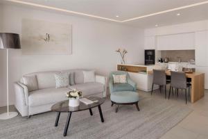 a living room with a couch and a table at Royal Hideaway Corales Suites in Adeje