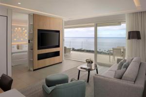 a living room with a view of the ocean at Royal Hideaway Corales Suites in Adeje