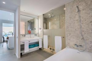 a bathroom with a tub and a sink and a shower at Royal Hideaway Corales Suites in Adeje