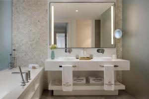 a bathroom with two sinks and a large mirror at Royal Hideaway Corales Suites in Adeje