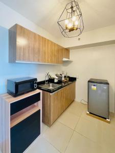 a kitchen with a sink and a microwave at * *K2 Nordic Haven in Iloilo City