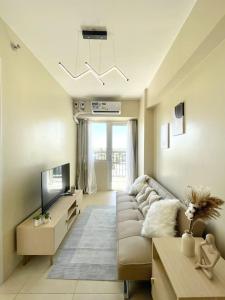 a living room with a couch and a tv at * *K2 Nordic Haven in Iloilo City