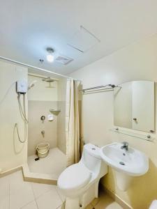 a white bathroom with a toilet and a sink at * *K2 Nordic Haven in Iloilo City