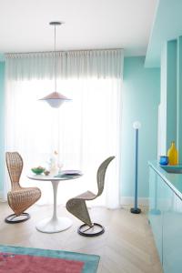 a dining room with a table and two chairs at Verde Acqua - Design & Comfort in Milan