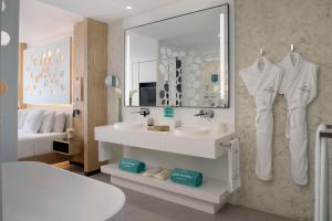 a white bathroom with a sink and a mirror at Royal Hideaway Corales Beach - Adults Only in Adeje