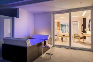 a living room with a blue bed and a living room at Royal Hideaway Corales Beach - Adults Only in Adeje