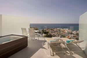 a balcony with a table and chairs and a view at Royal Hideaway Corales Beach - Adults Only in Adeje