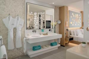 a white bathroom with a sink and a mirror at Royal Hideaway Corales Beach - Adults Only in Adeje
