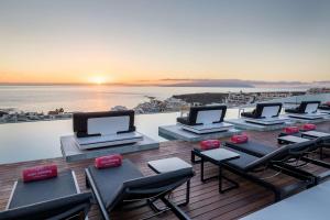 a balcony with chairs and tables on a cruise ship at Royal Hideaway Corales Beach - Adults Only in Adeje