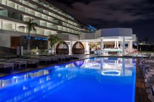 a view of a hotel pool at night at Royal Hideaway Corales Beach - Adults Only in Adeje