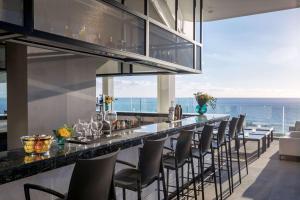a bar with chairs and a view of the ocean at Royal Hideaway Corales Beach - Adults Only in Adeje