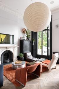 a living room with a couch and a coffee table at The Bengal Tiger in Notting Hill in London