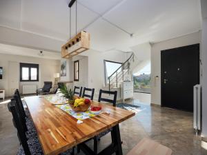 a kitchen and dining room with a wooden table at Galina's Greek House in Artemida