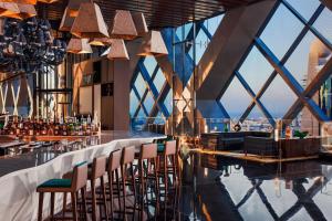 a bar with chairs and a view of the city at One&Only One Za'abeel in Dubai