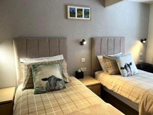 a bedroom with two beds with a dog pillow at Shaftoe's Bed and Breakfast in Haydon Bridge