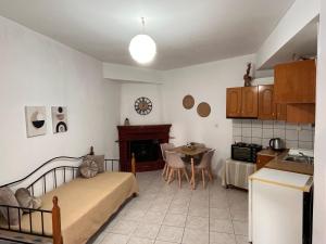 a living room with a bed and a kitchen at Maria Apts in Istro